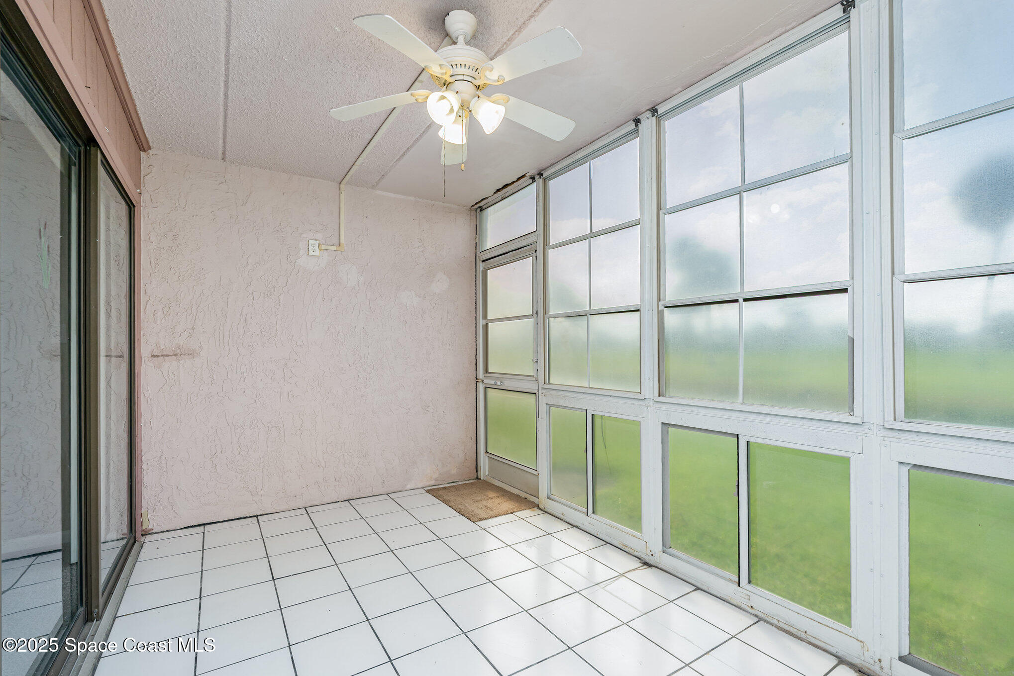 2727 North Wickham Road, Unit 10210 Melbourne, FL 32935 - Photo 21 of 35 a view of an empty room with a chandelier fan