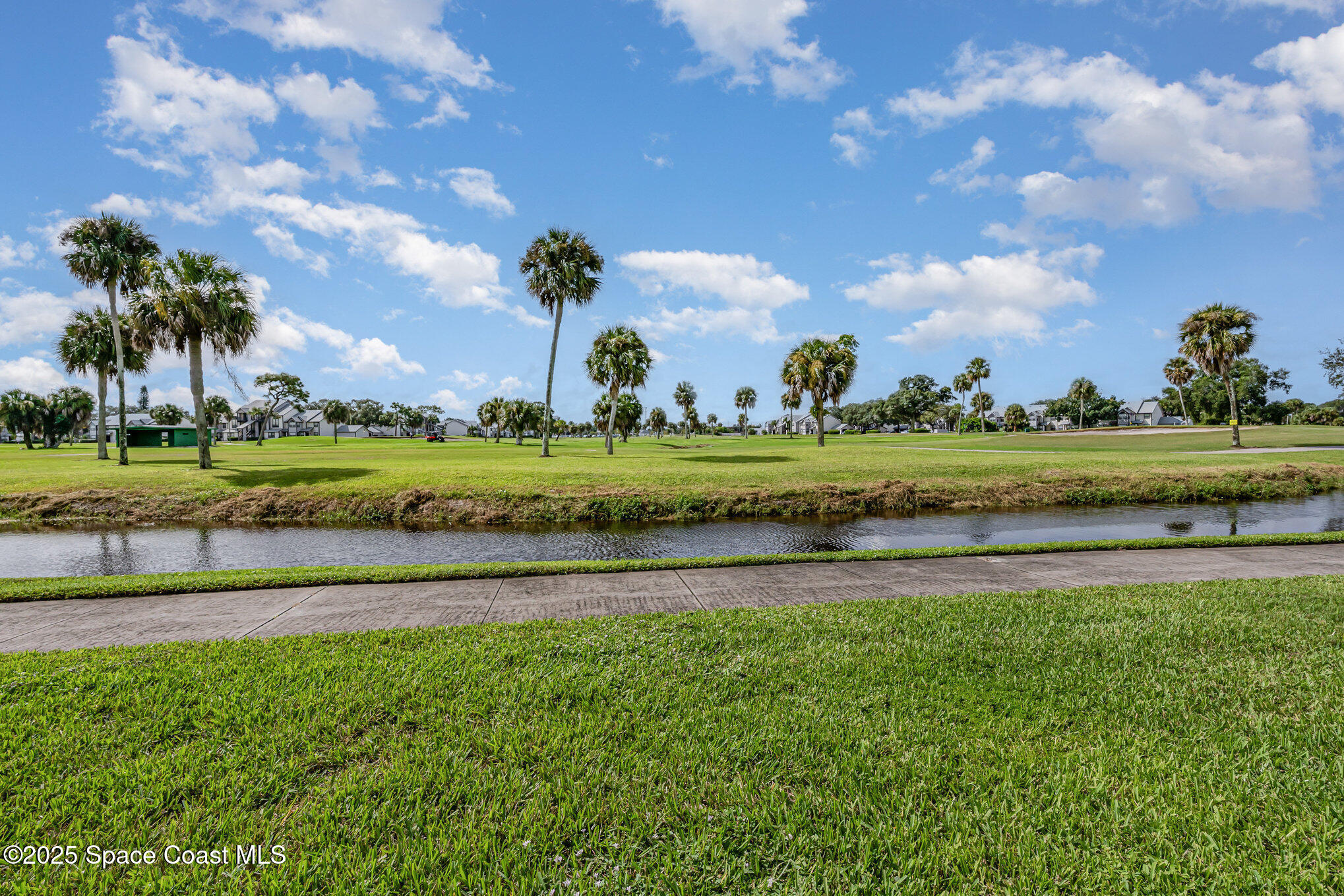 2727 North Wickham Road, Unit 10210 Melbourne, FL 32935 - Photo 22 of 35 a view of a golf course with a house