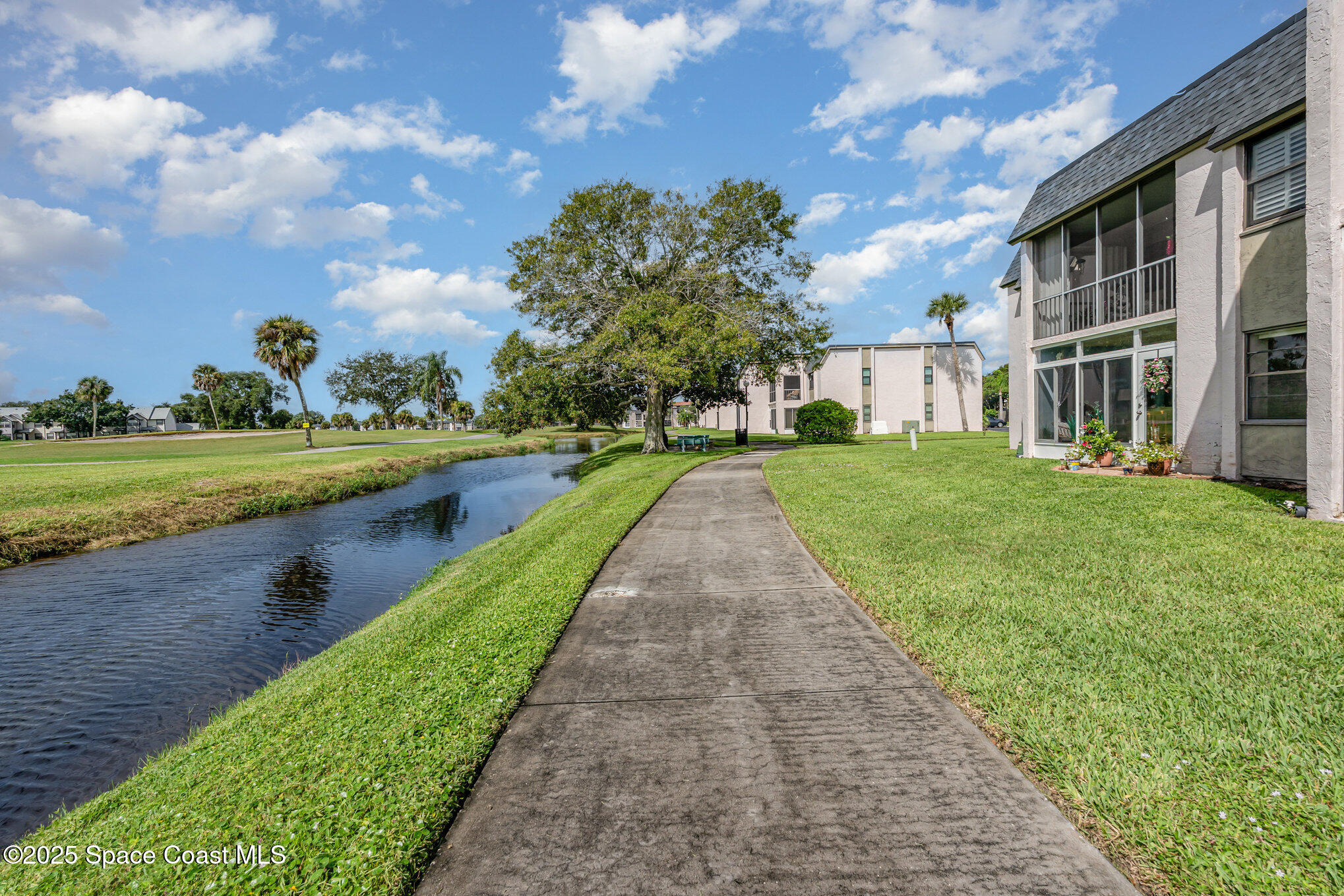 2727 North Wickham Road, Unit 10210 Melbourne, FL 32935 - Photo 25 of 35 a view of a house with a yard and sitting area