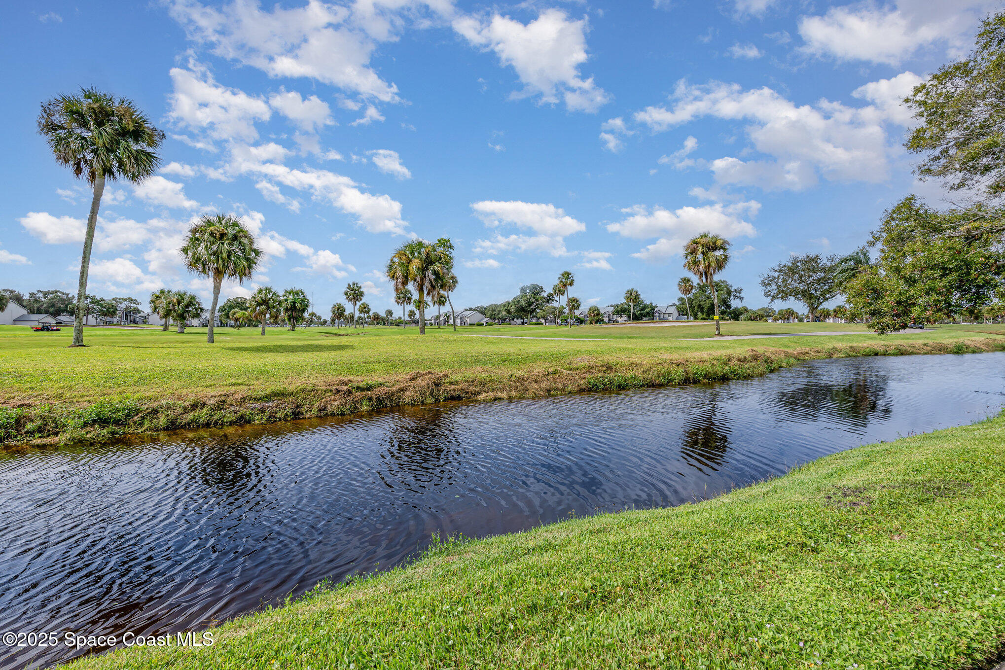 2727 North Wickham Road, Unit 10210 Melbourne, FL 32935 - Photo 26 of 35 a view of a lake with a big yard and potted plants