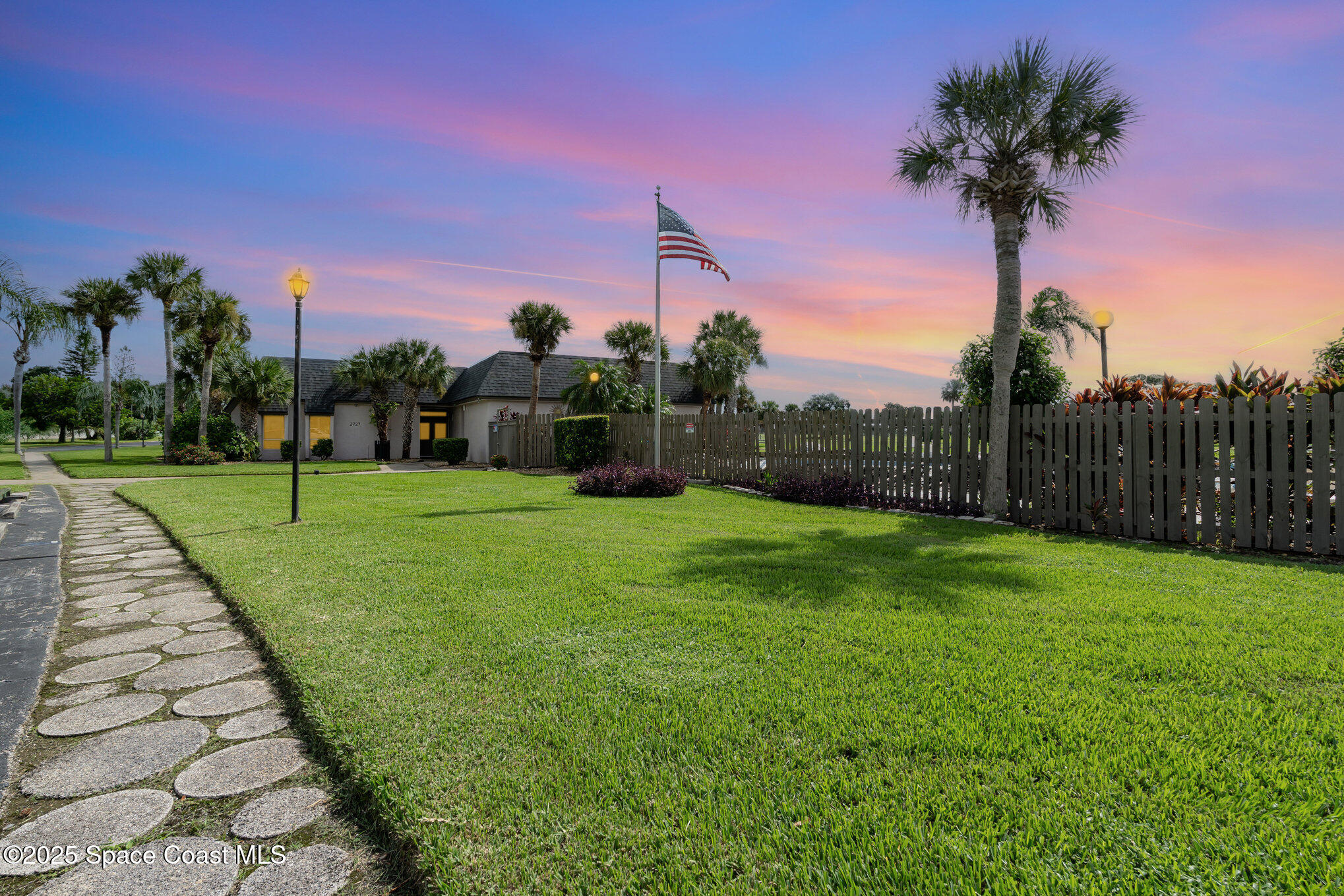2727 North Wickham Road, Unit 10210 Melbourne, FL 32935 - Photo 3 of 35 a view of a garden with a house