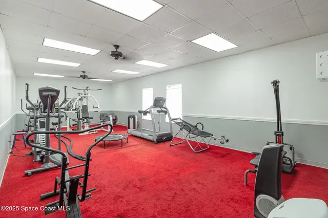 a room with gym equipment and windows