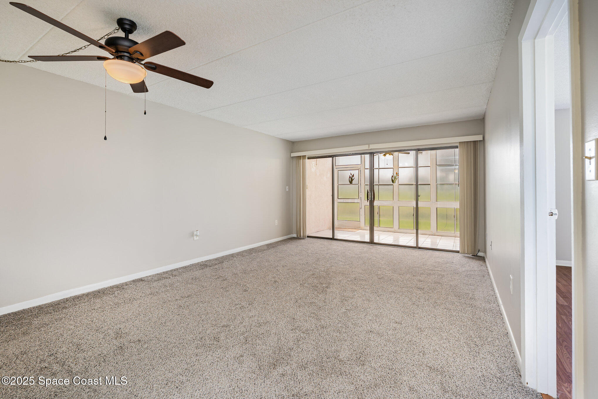 2727 North Wickham Road, Unit 10210 Melbourne, FL 32935 - Photo 7 of 35 a view of an empty room with a window