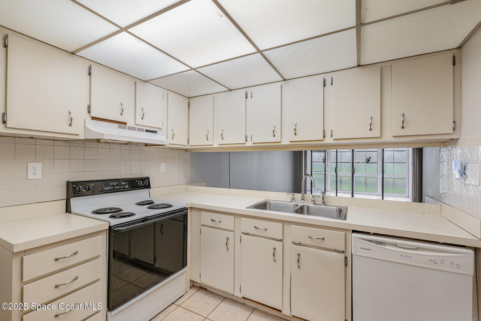 2727 North Wickham Road, Unit 10210 Melbourne, FL 32935 - Photo 10 of 35 a kitchen with stainless steel appliances granite countertop a sink stove and cabinets