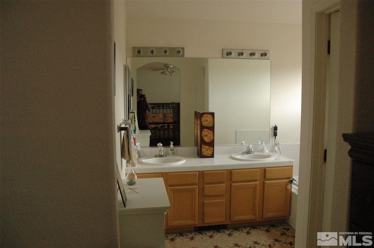 14661 Gold Run Drive Reno, NV 89521 - Photo 7 of 12 a bathroom with a sink and a mirror