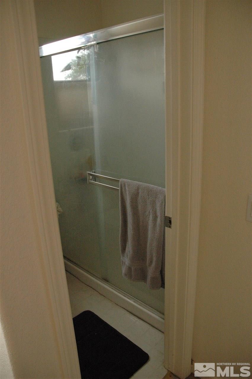 14661 Gold Run Drive Reno, NV 89521 - Photo 8 of 12 a bathroom with a glass shower door