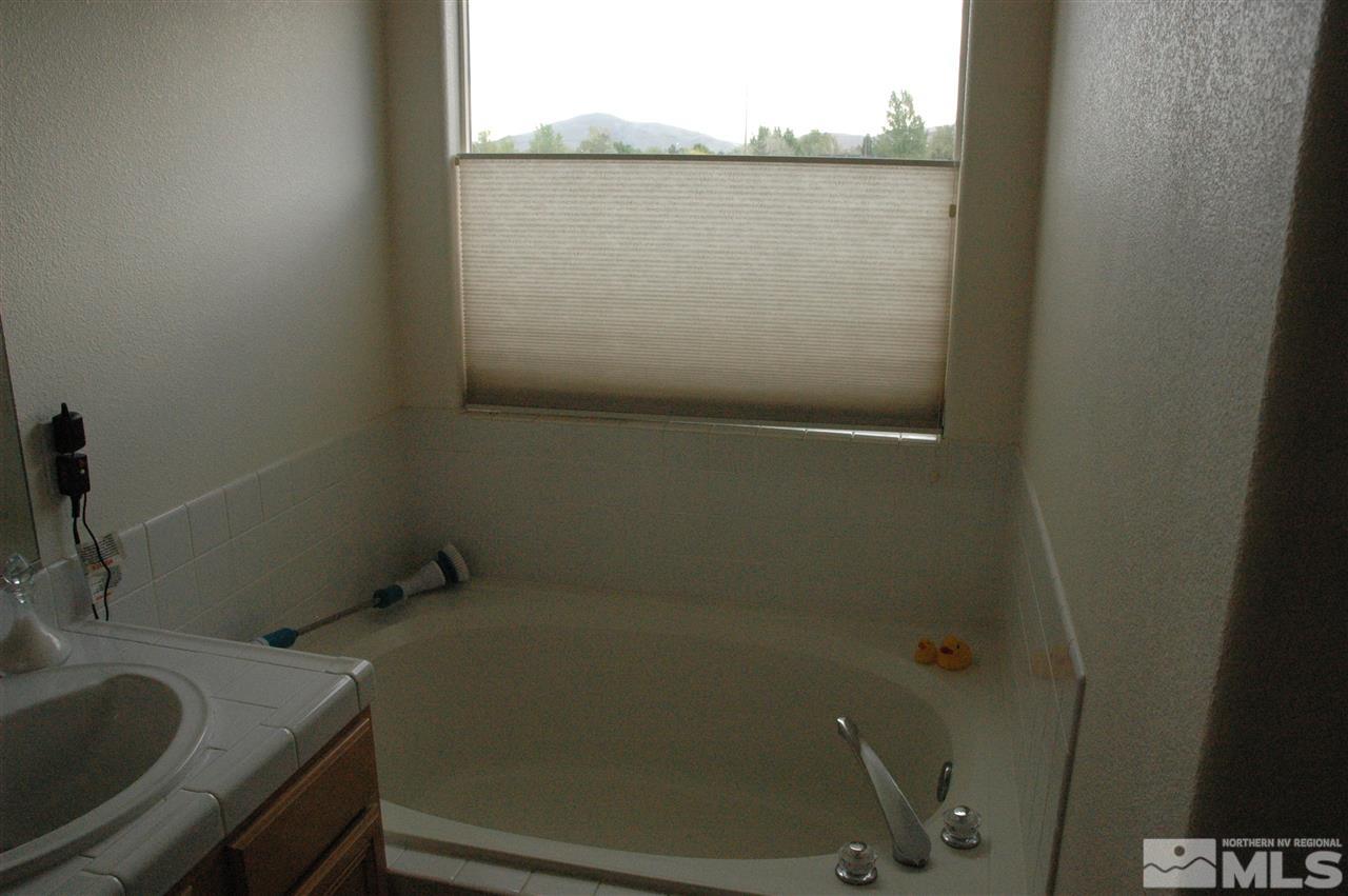 14661 Gold Run Drive Reno, NV 89521 - Photo 9 of 12 a bathroom with a sink and mirror