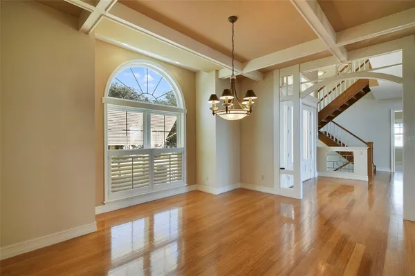 a view of a livingroom with wooden floor and a window