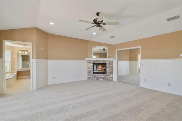 a view of an empty room with a kitchen