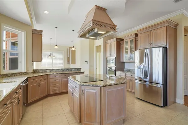 a kitchen with stainless steel appliances granite countertop a refrigerator and a sink