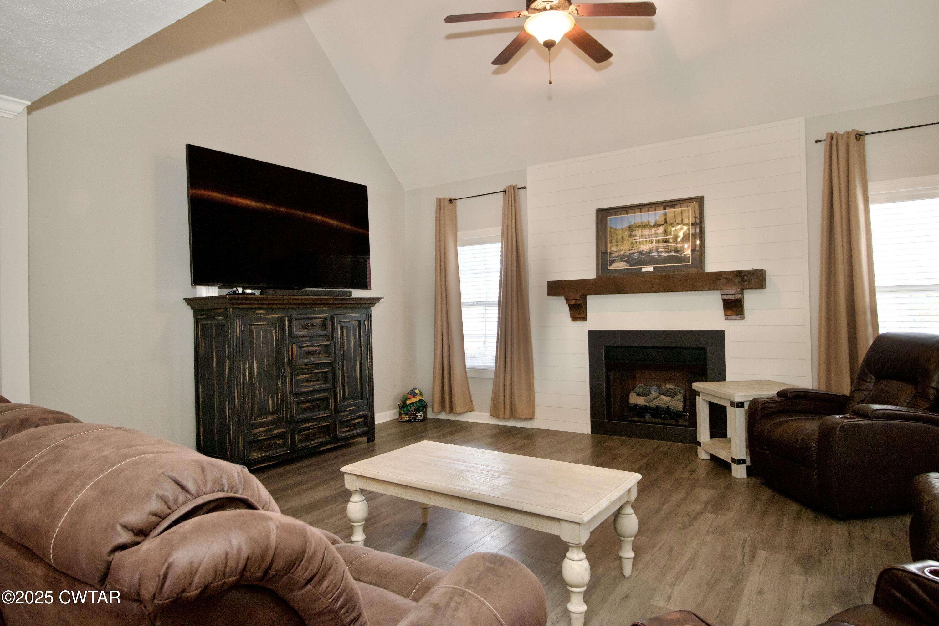 177 Fawn Ridge Lane Medina, TN 38355 - Photo 13 of 44 a living room with furniture a flat screen tv and a fireplace