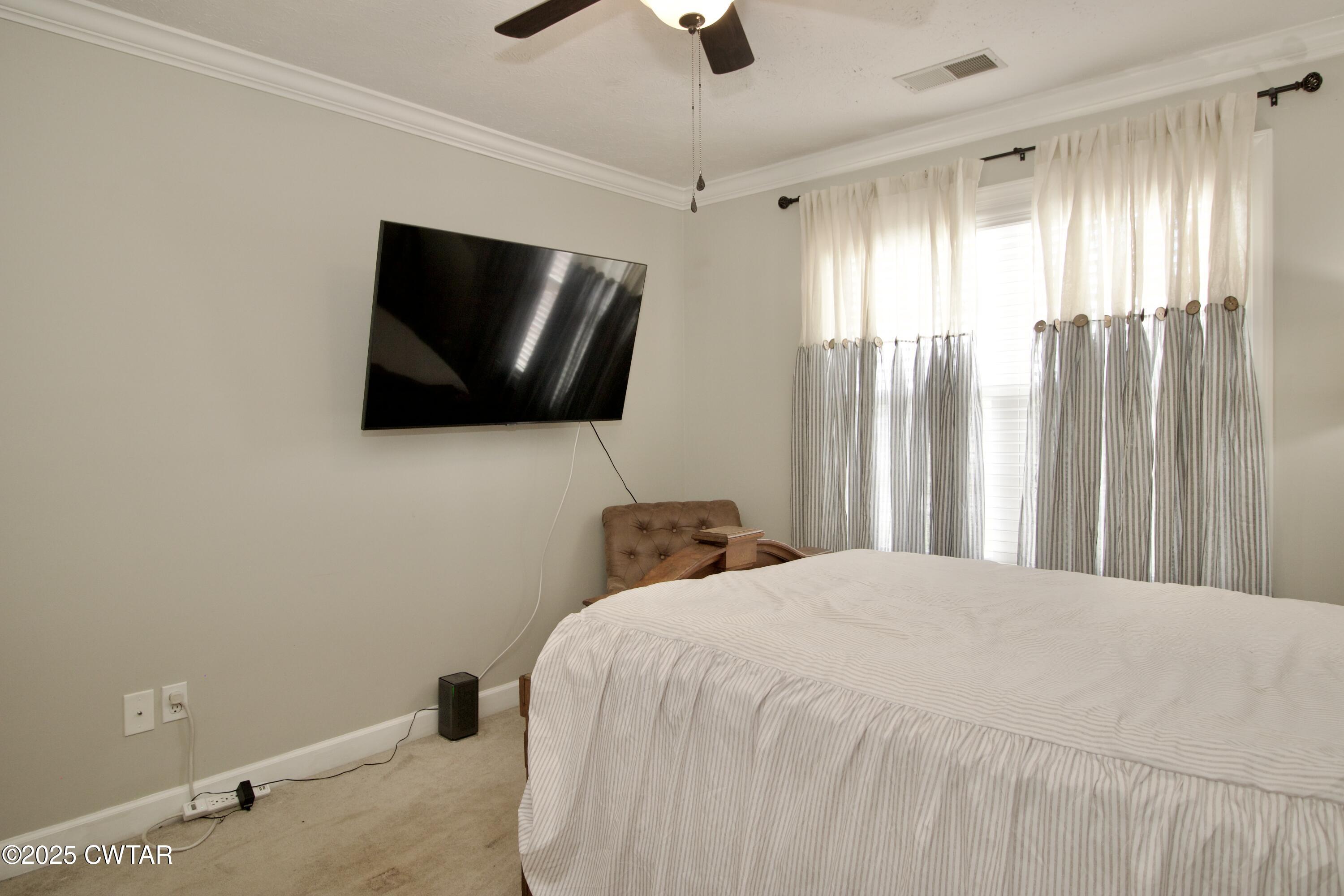 177 Fawn Ridge Lane Medina, TN 38355 - Photo 18 of 44 a bedroom with a bed and a flat screen tv