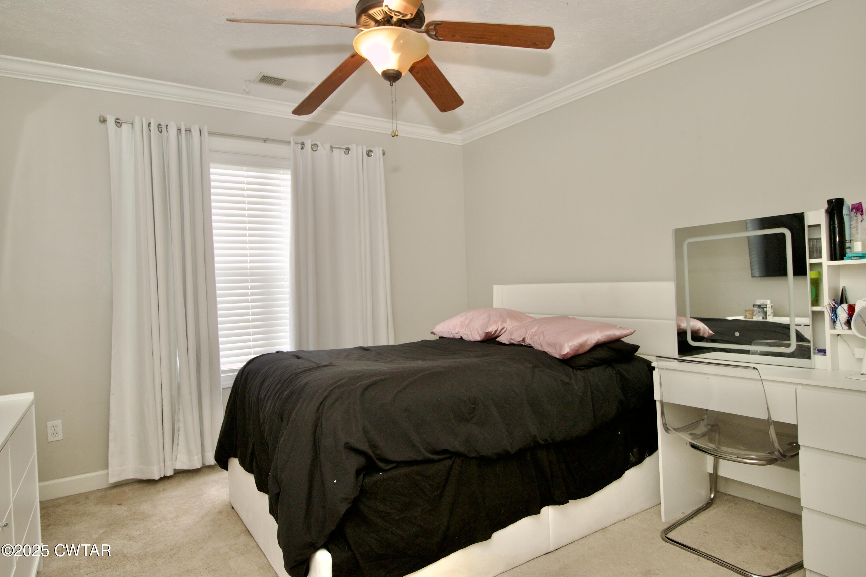 177 Fawn Ridge Lane Medina, TN 38355 - Photo 20 of 44 a bedroom with a bed and a chandelier