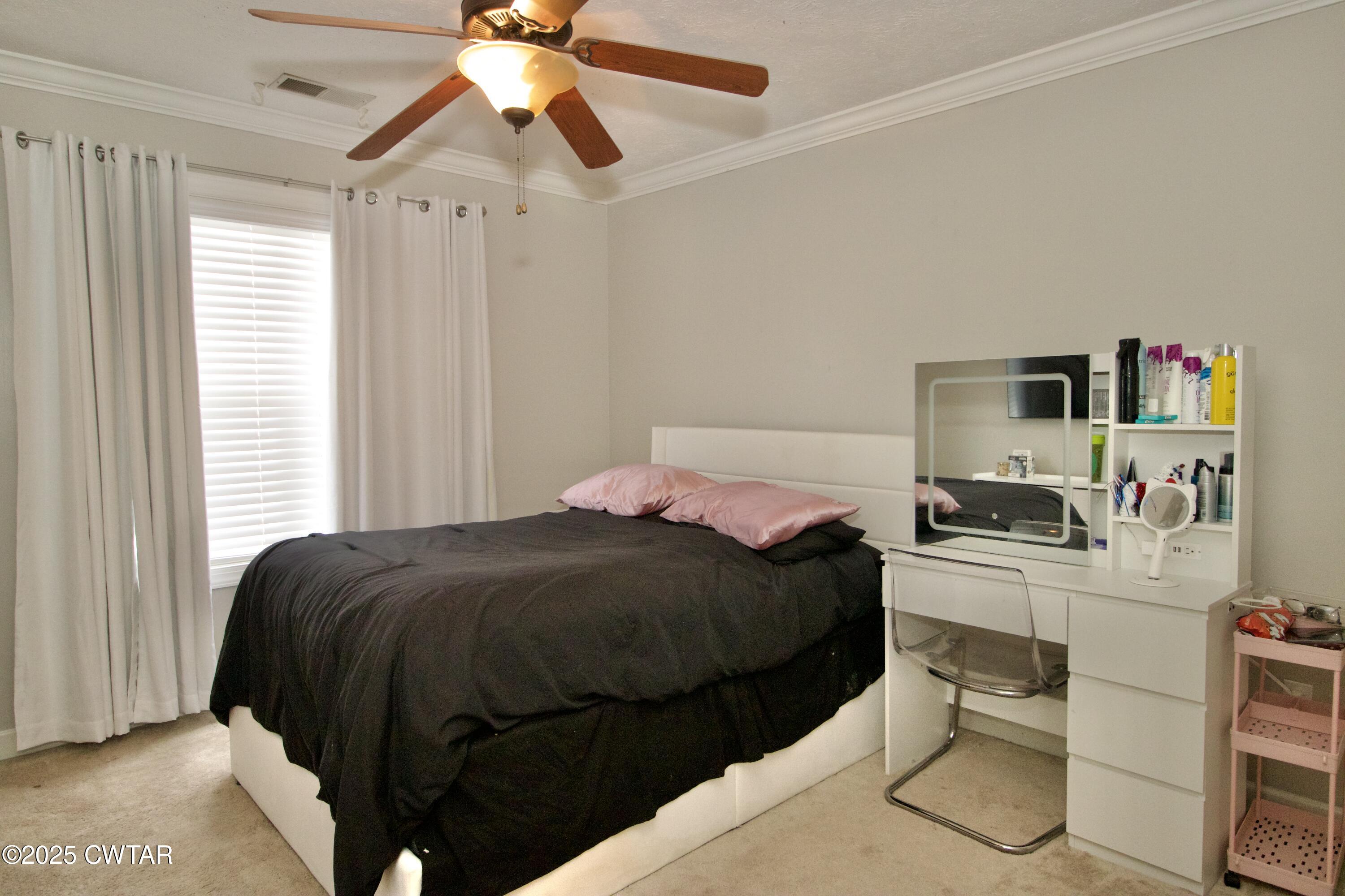177 Fawn Ridge Lane Medina, TN 38355 - Photo 25 of 44 a bedroom with a bed and a chandelier