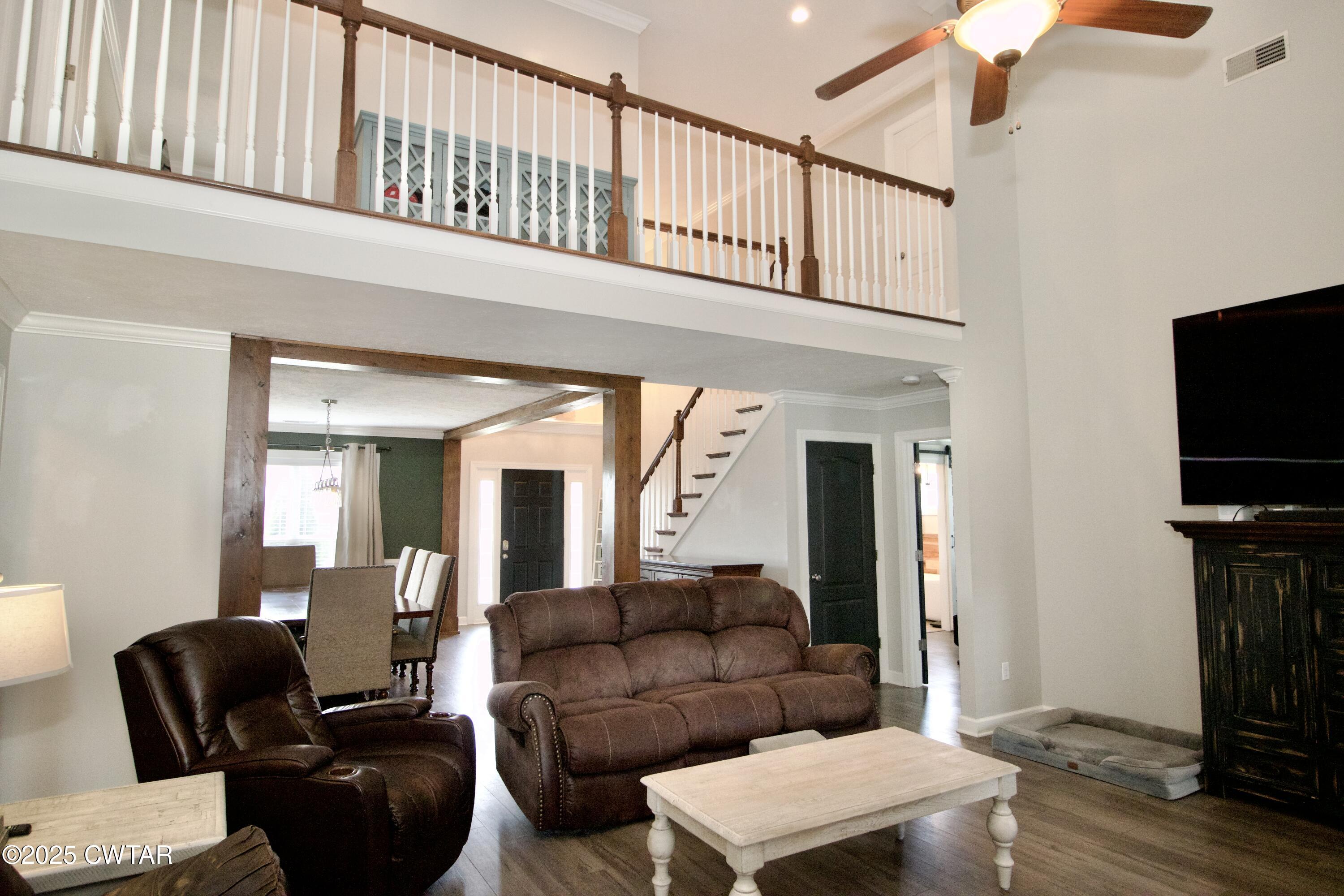 177 Fawn Ridge Lane Medina, TN 38355 - Photo 28 of 44 a living room with furniture a flat screen tv and a refrigerator