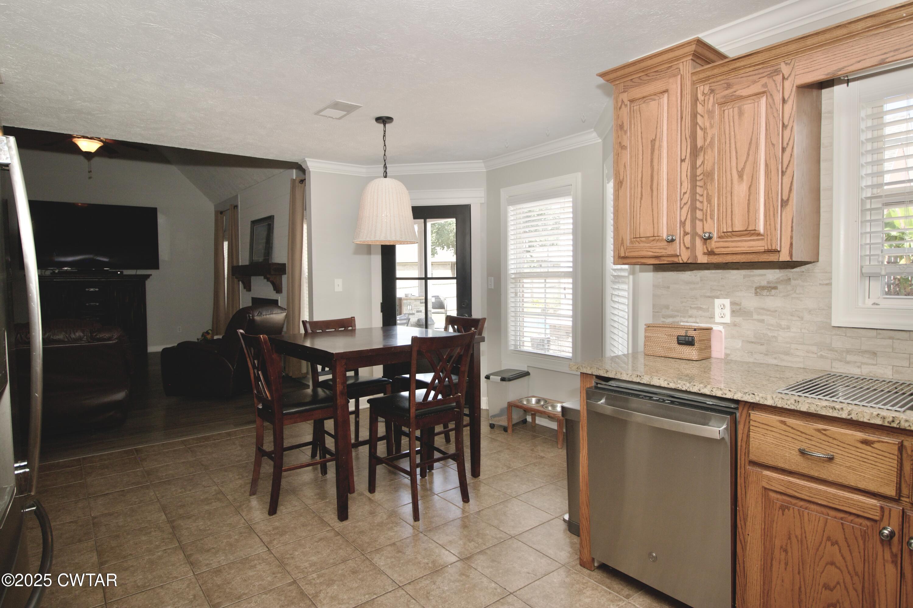 177 Fawn Ridge Lane Medina, TN 38355 - Photo 31 of 44 a kitchen with stainless steel appliances granite countertop a sink a stove and a refrigerator