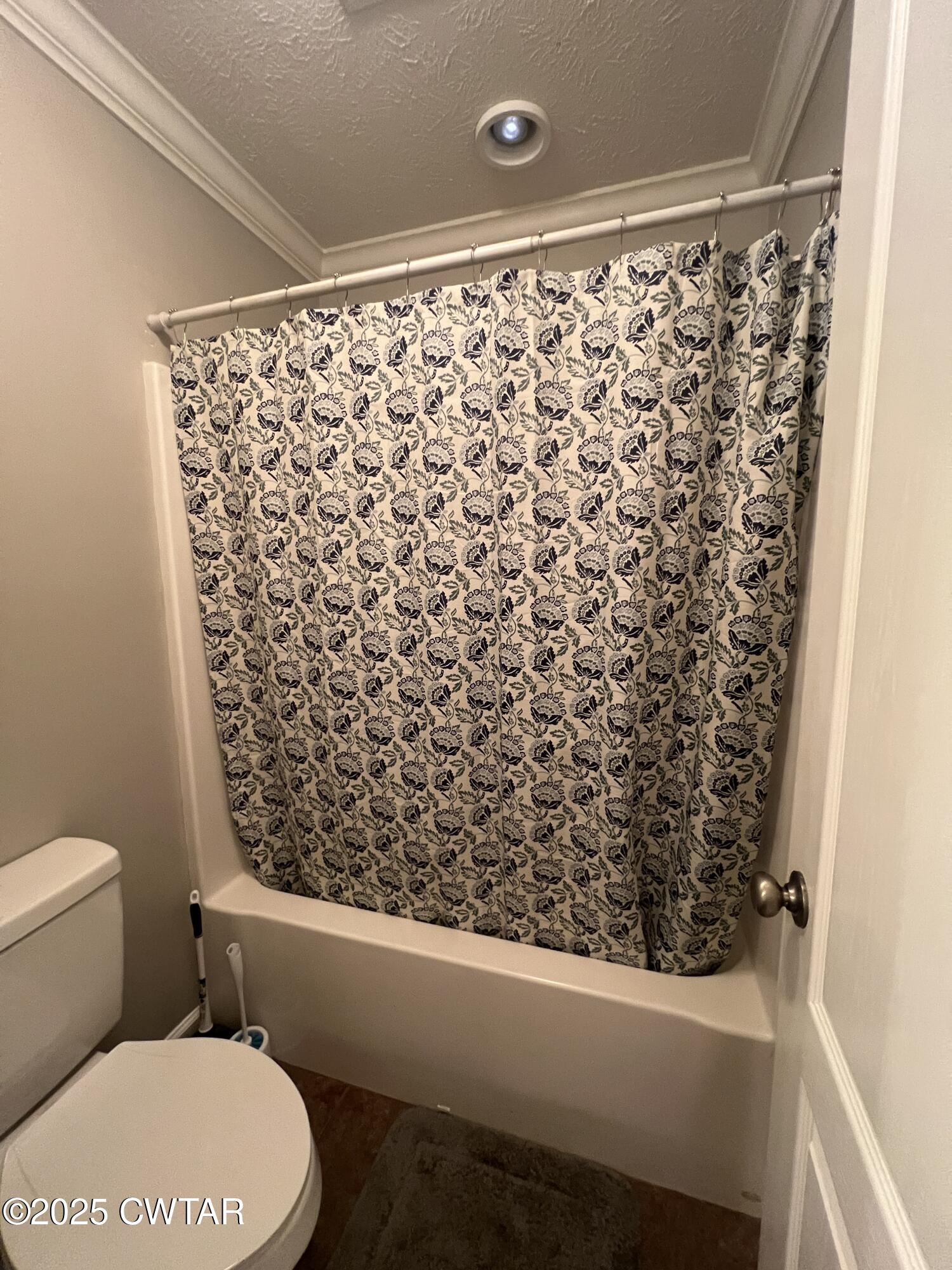 177 Fawn Ridge Lane Medina, TN 38355 - Photo 40 of 44 a bathroom with a toilet and a shower curtain