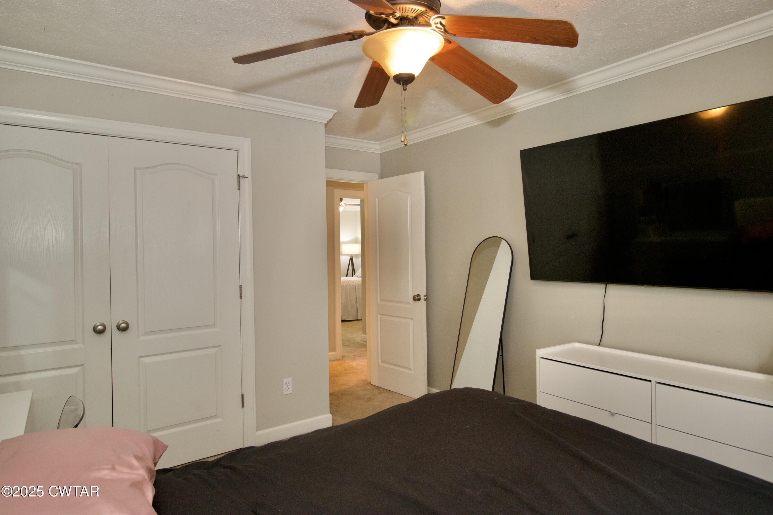 177 Fawn Ridge Lane Medina, TN 38355 - Photo 8 of 44 a bedroom with a bed and a flat screen tv