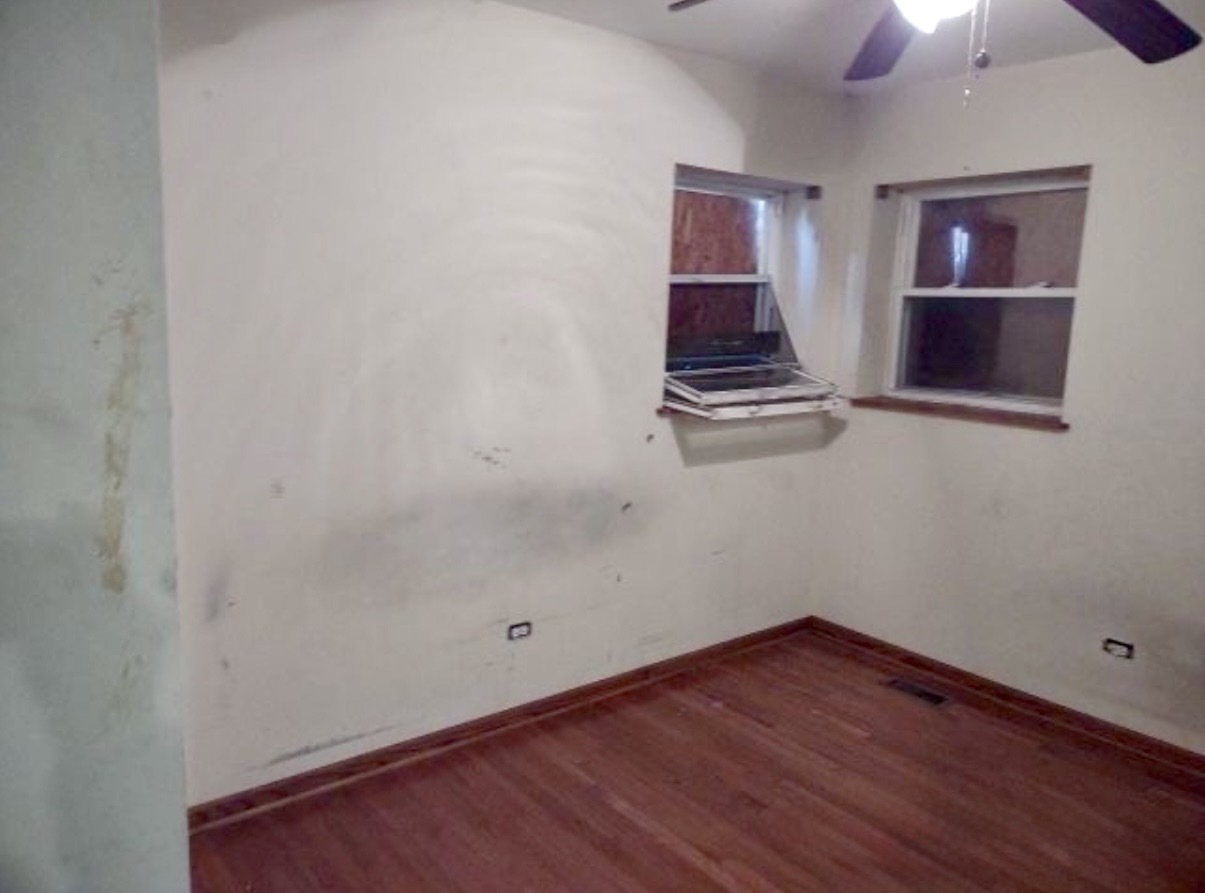 9356 South Oglesby Avenue Chicago, IL 60617 - Photo 8 of 12 a view of a room with wooden floor and white walls