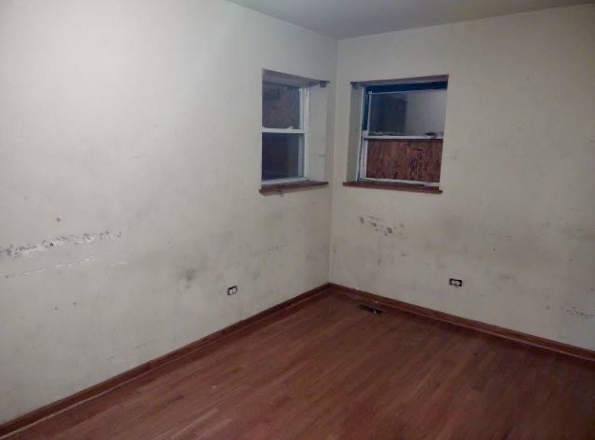 9356 South Oglesby Avenue Chicago, IL 60617 - Photo 10 of 12 a room with window and wooden floor