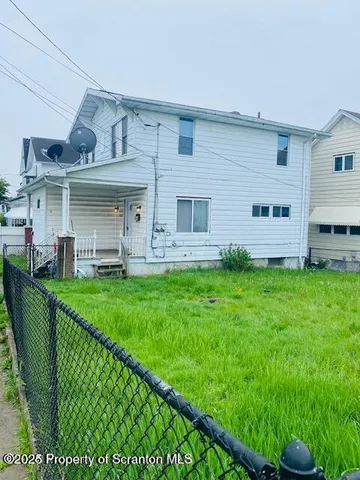 a view of a house with backyard sitting area and garden