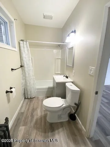 a bathroom with a toilet a sink and a mirror