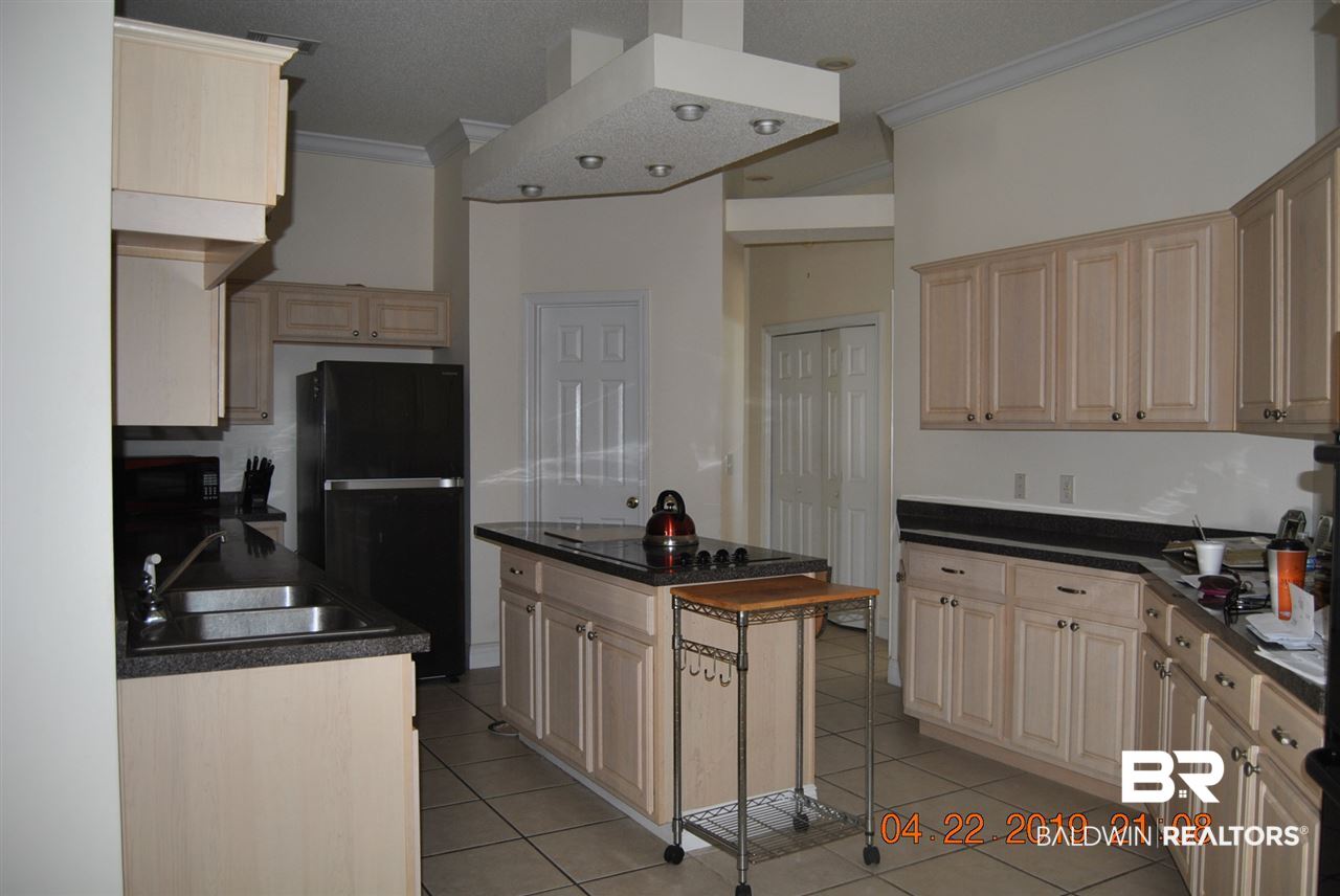 411 Juniper Creek Road Brewton, AL 36426 - Photo 15 of 35 Kitchen has lot of cabinets center island and pant