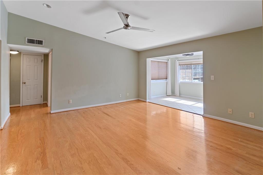 1468 Briarwood Road Northeast, Unit 1104 Atlanta, GA 30319 - Photo 1 of 15 a view of an empty room with window and wooden floor