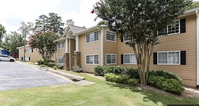 a front view of a house with yard and trees
