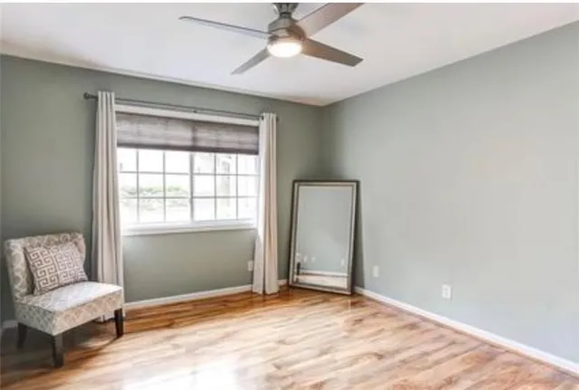 a view of room with window and ceiling fan