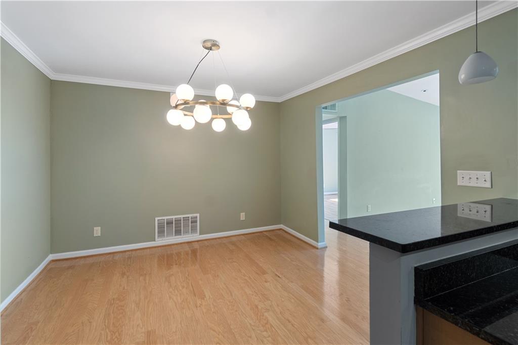 1468 Briarwood Road Northeast, Unit 1104 Atlanta, GA 30319 - Photo 7 of 15 a view of a chandelier fan and wooden floor