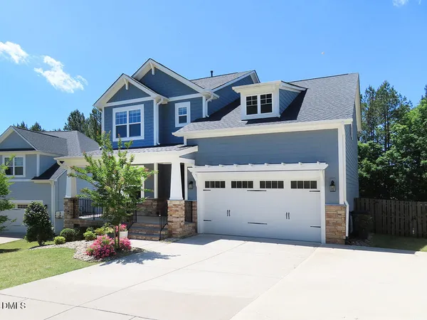 a front view of a house with yard
