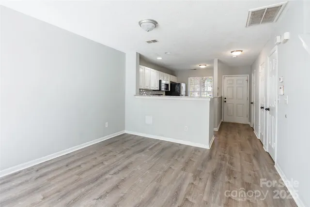 a view of a kitchen with a sink and a refrigerator