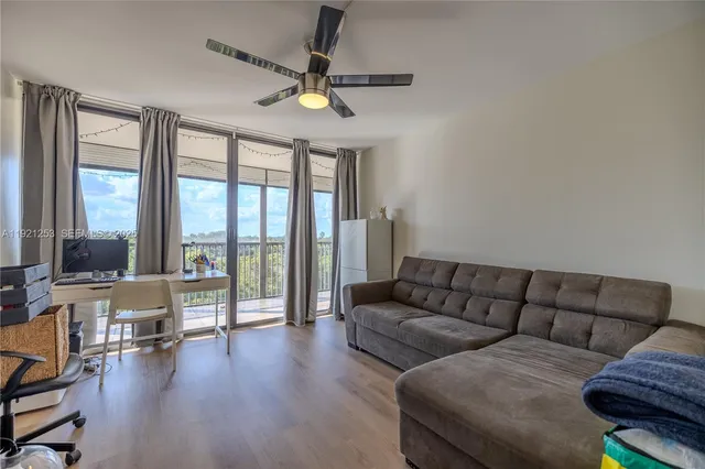 a living room with furniture and a large window