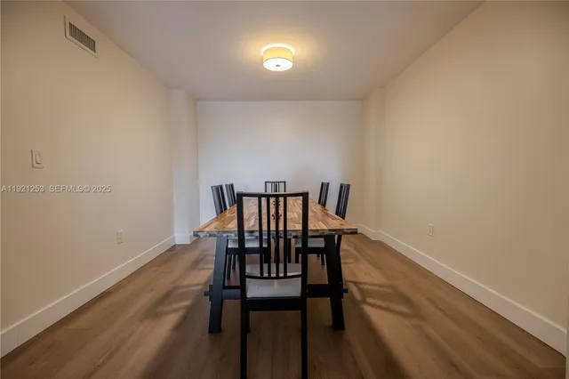 a view of a room with furniture and wooden floor