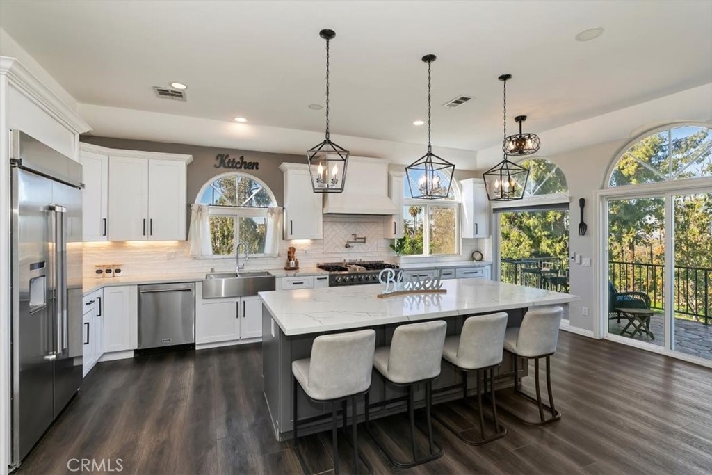 1619 Gratton Street Riverside, CA 92504 - Photo 20 of 62 a large kitchen with a table and chairs