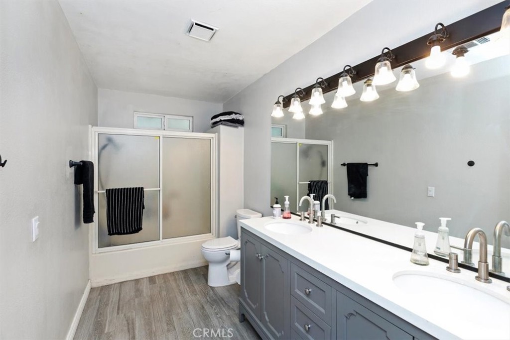 1619 Gratton Street Riverside, CA 92504 - Photo 34 of 62 a bathroom with a double vanity sink mirror and shower