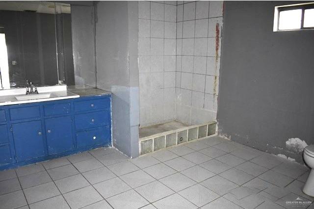 1851 3 Mile Line Road Penitas, TX 78576 - Photo 7 of 21 a bathroom with a sink and a mirror