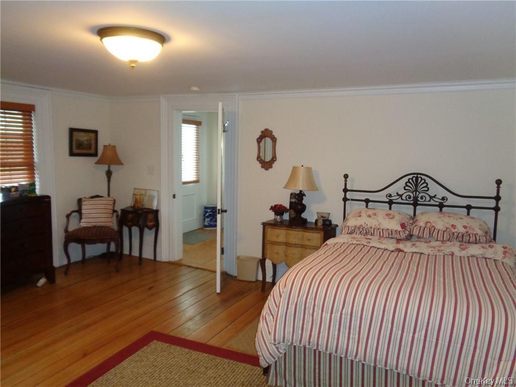 669 Mountain Road Bloomingburg, NY 12721 - Photo 23 of 36 Bedroom with wood-type flooring and crown molding