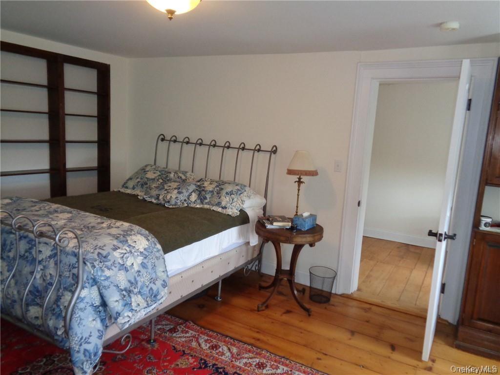 669 Mountain Road Bloomingburg, NY 12721 - Photo 28 of 36 Bedroom featuring light wood-style flooring and baseboards