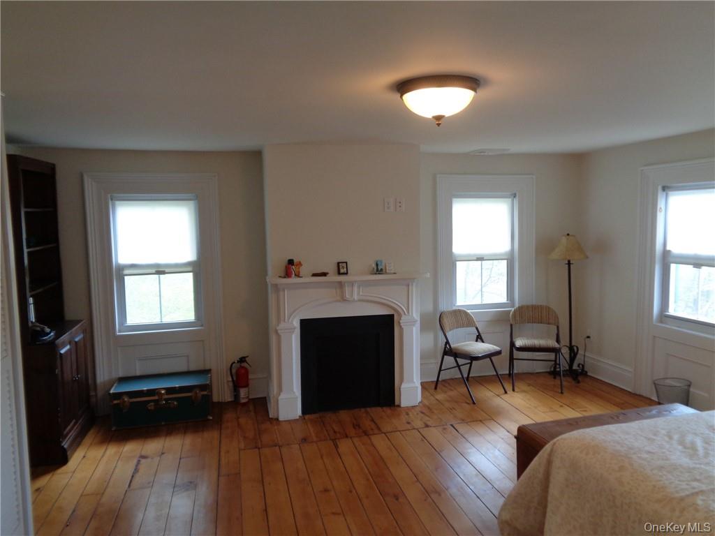 669 Mountain Road Bloomingburg, NY 12721 - Photo 32 of 36 Bedroom with multiple windows and hardwood / wood-style floors