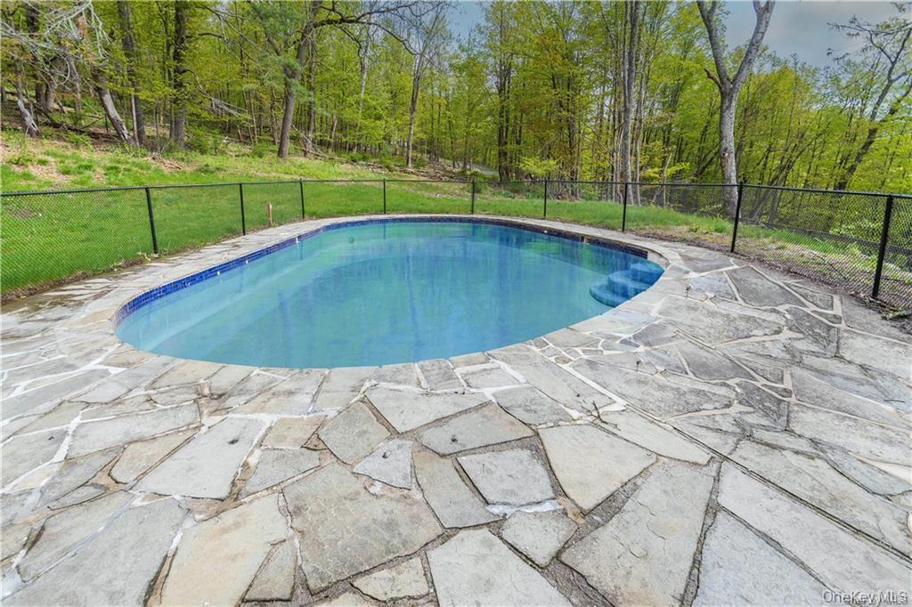 669 Mountain Road Bloomingburg, NY 12721 - Photo 7 of 36 View of pool featuring a fenced backyard and patio surround