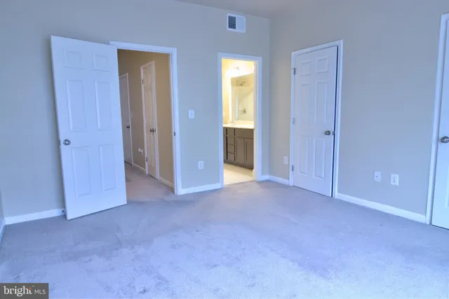 a bathroom with a double vanity sink toilet and a mirror