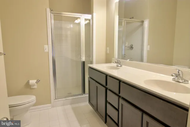 a bathroom with a sink toilet and a mirror