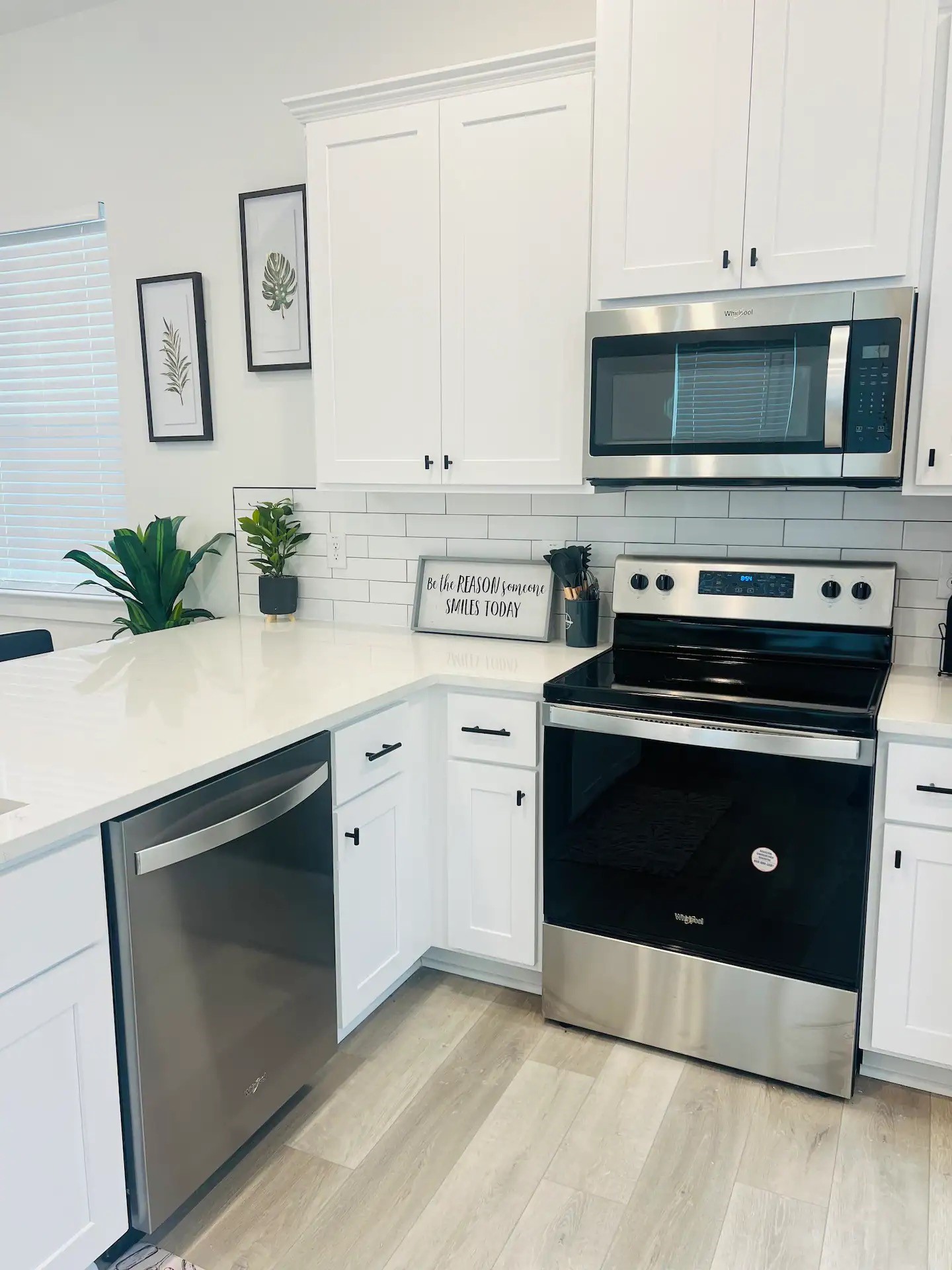 8508 Wileyvale Road, Unit B Houston, TX 77016 - Photo 3 of 16 a kitchen with stainless steel appliances a stove a microwave a sink and cabinets
