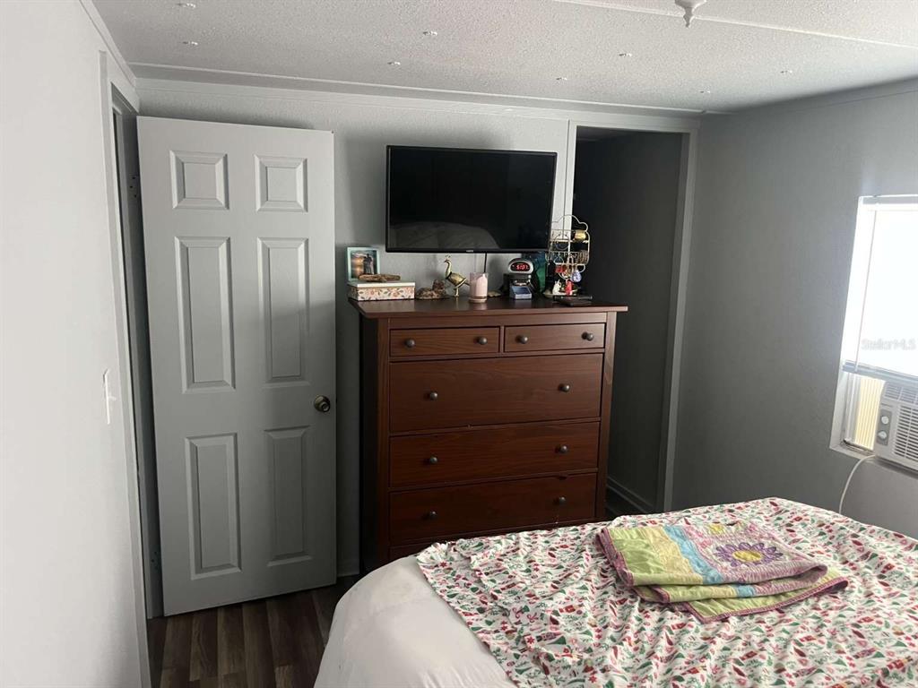 1511 Gaines Road Winter Haven, FL 33880 - Photo 11 of 20 a bedroom with a bed and a flat screen tv