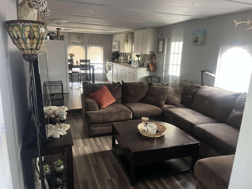 1511 Gaines Road Winter Haven, FL 33880 - Photo 12 of 20 a living room with furniture and a chandelier