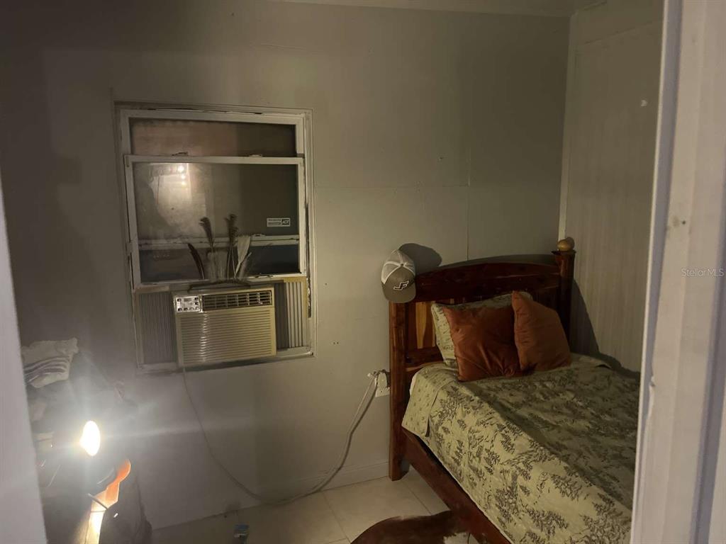 1511 Gaines Road Winter Haven, FL 33880 - Photo 14 of 20 a bedroom with a bed and furniture