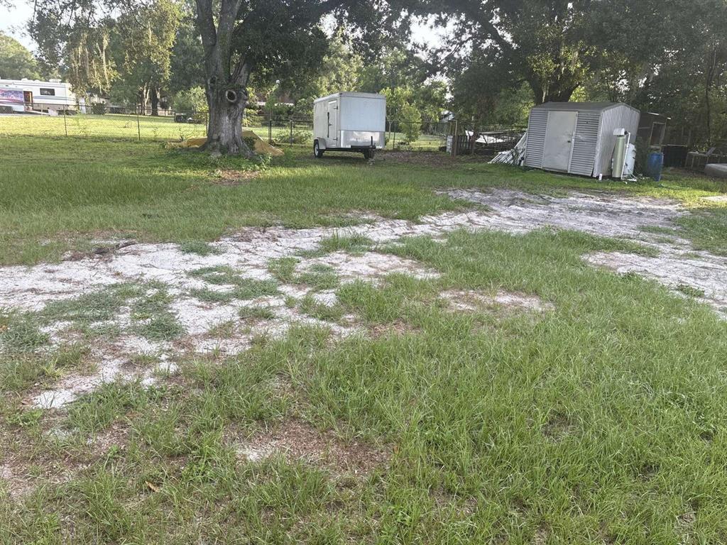 1511 Gaines Road Winter Haven, FL 33880 - Photo 16 of 20 a backyard of a house with trees and outdoor space