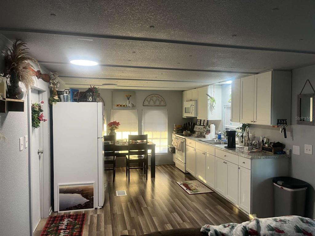 1511 Gaines Road Winter Haven, FL 33880 - Photo 2 of 20 a kitchen with a sink appliances and cabinets